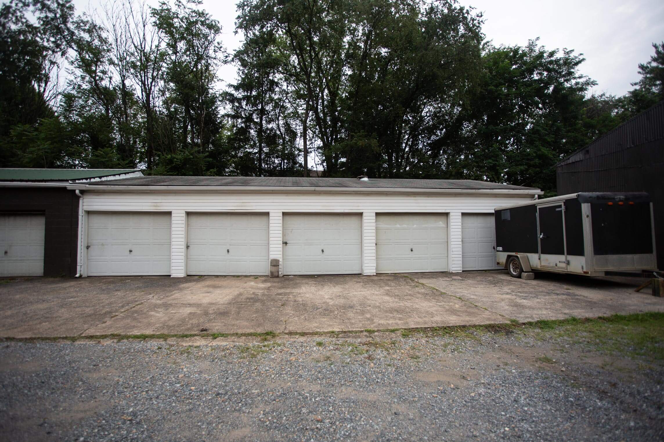 Wide-angle shot of multiple garage bays on a commercial property, illustrating We Buy Garages’ latest investment in Central PA